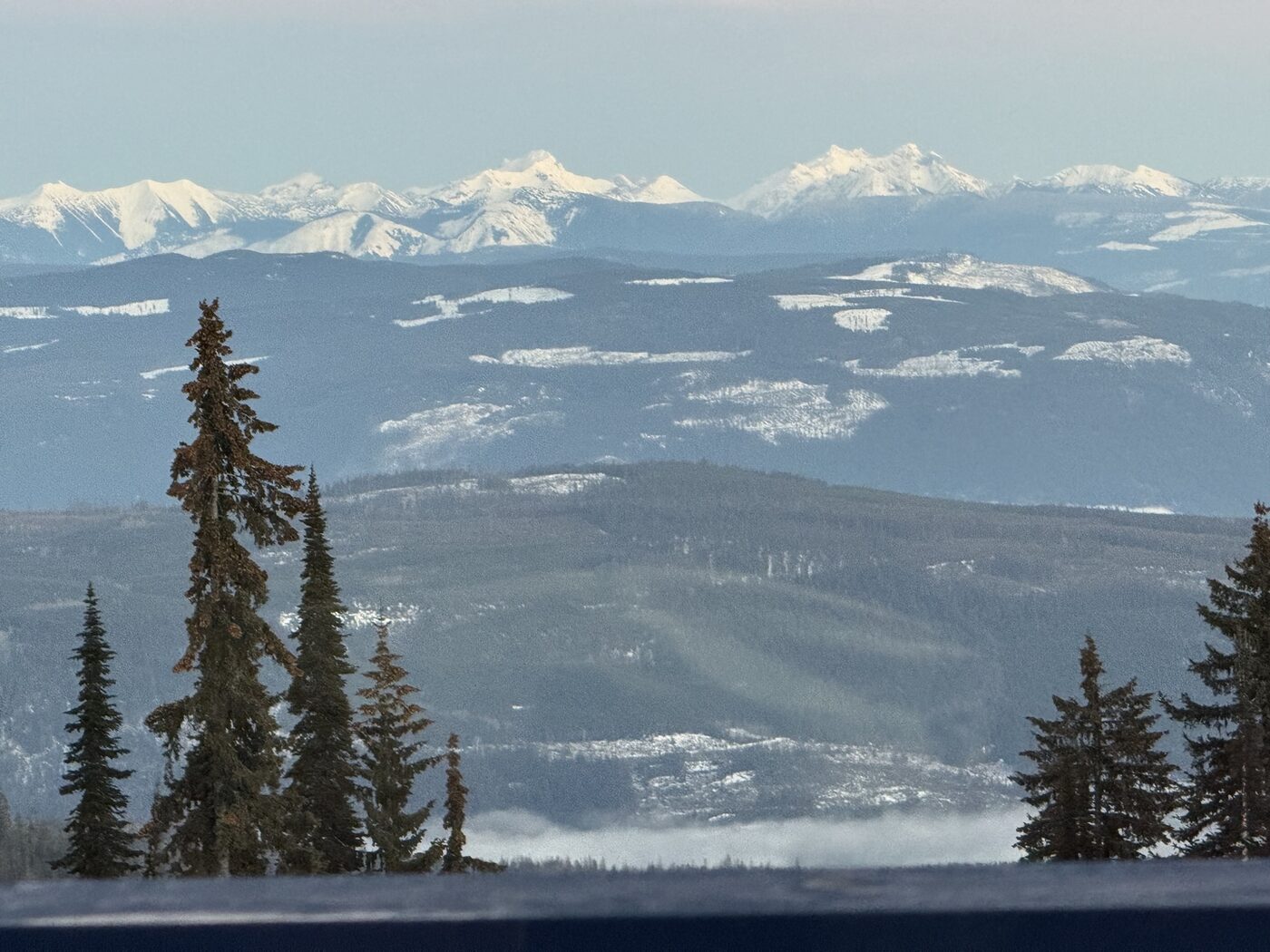 Snow-capped mountain ranges stretching to the horizon, viewed from SilverStar